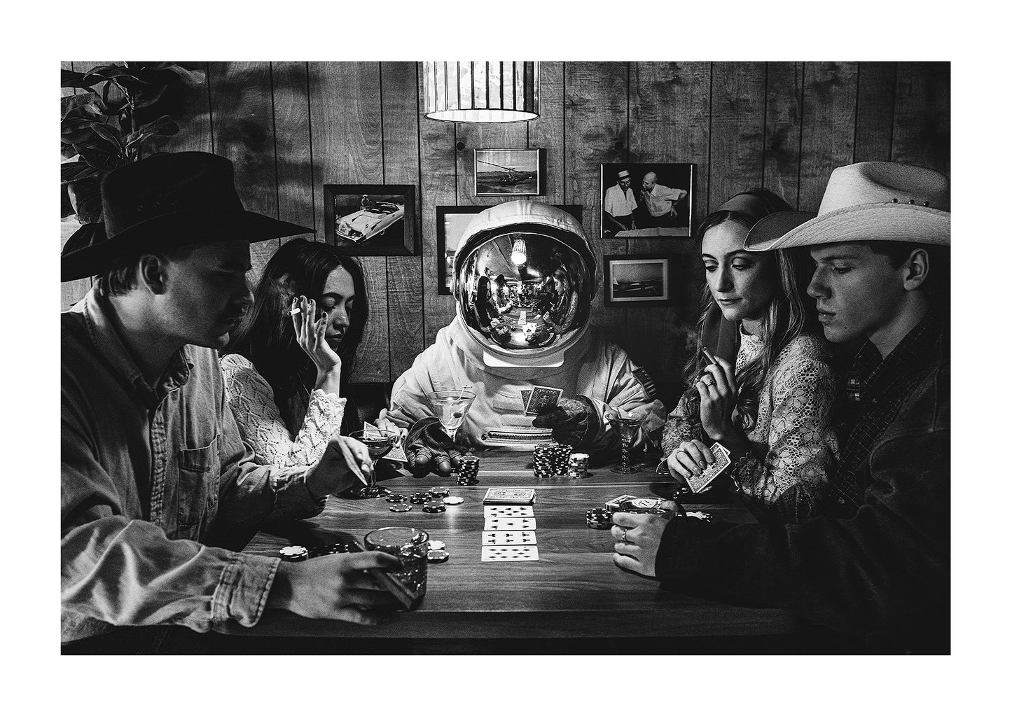 Astronaut playing poker in a western bar with a bunch of cowboys.