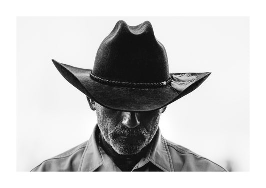Black and white photograph of a cowboy and cowboy hat, part of a Western cowboy photography series.
