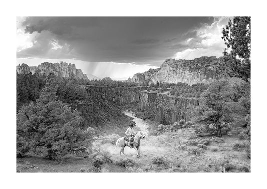 "Legacy" cowboy in front of grand landscape print for sale.