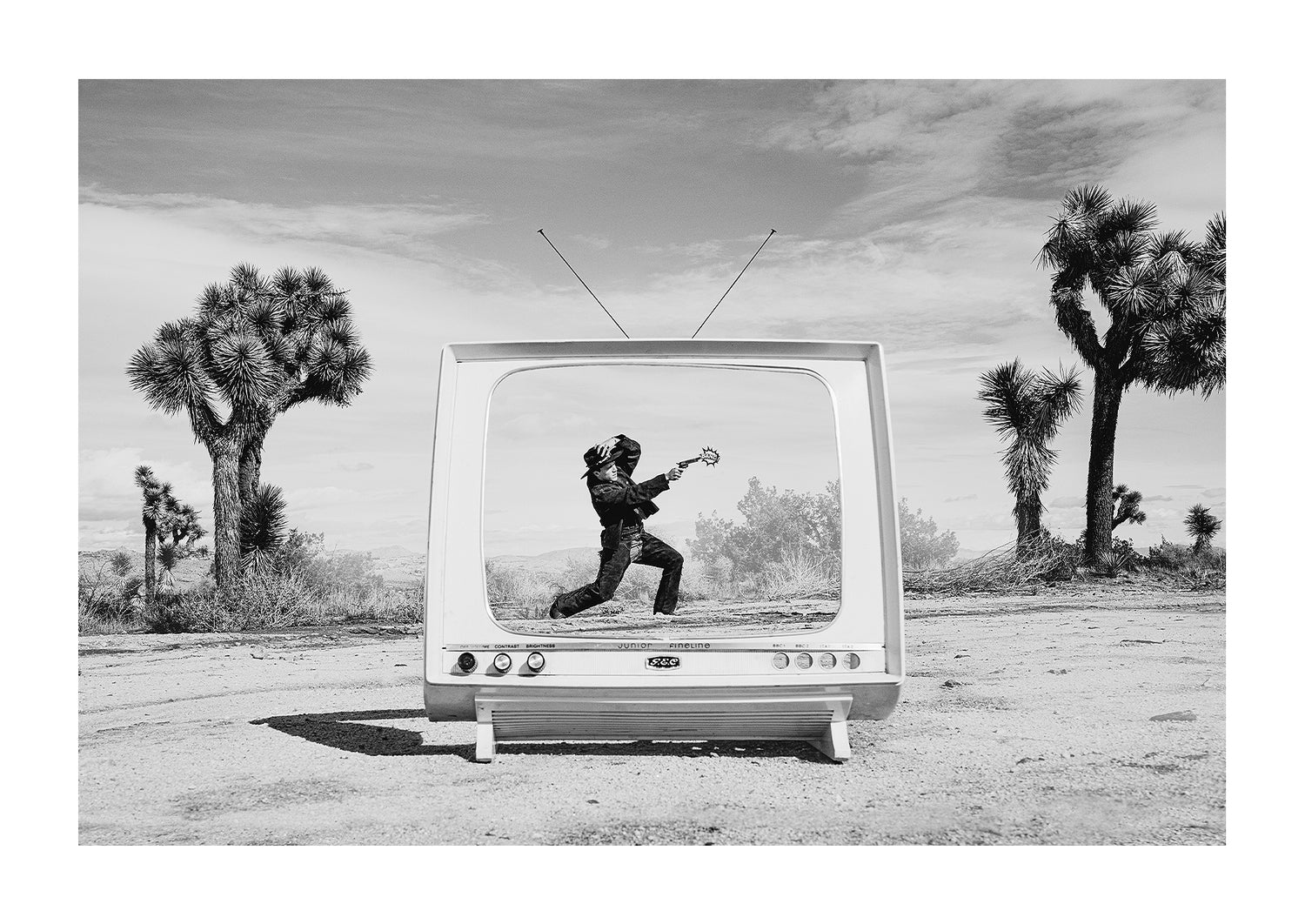 Cowboy inside a mid-century modern TV in the desert with a vintage "BANG" sign coming out the gun. 
