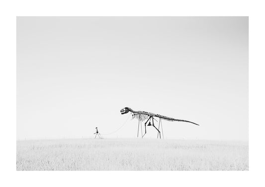 "rex" a skelton man walking a pet t-rex dinosaur on a leash in black and white.